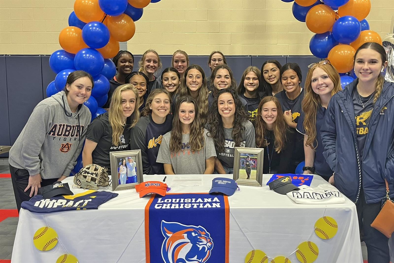 Cy Ranch senior Emily Landry, seated center, smiles after signing a letter of intent to Louisiana Christian University.